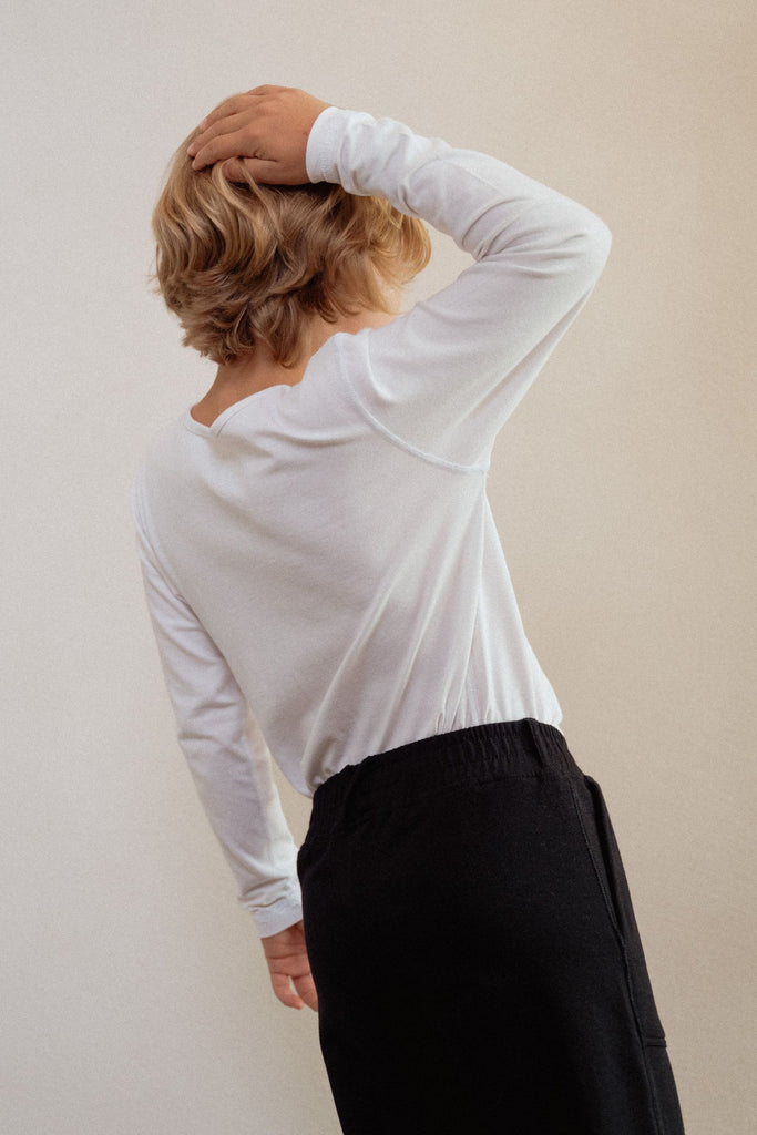 Long-sleeve white without seams or labels for ultimate sensory friendly comfort, perfect for children with sensitive skin or high sensory needs. Pair with SAM's ZEN chewy fidget for reduced stress and improved focus.