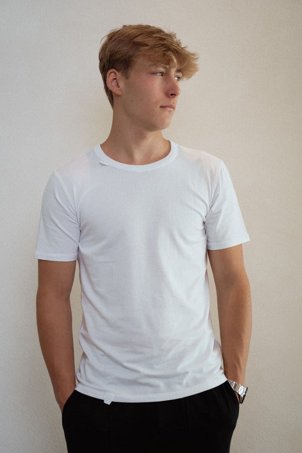 Sensory friendly seamless soft white T-shirt without labels or tags for sensory sensitive adults or people with sensitive skin.