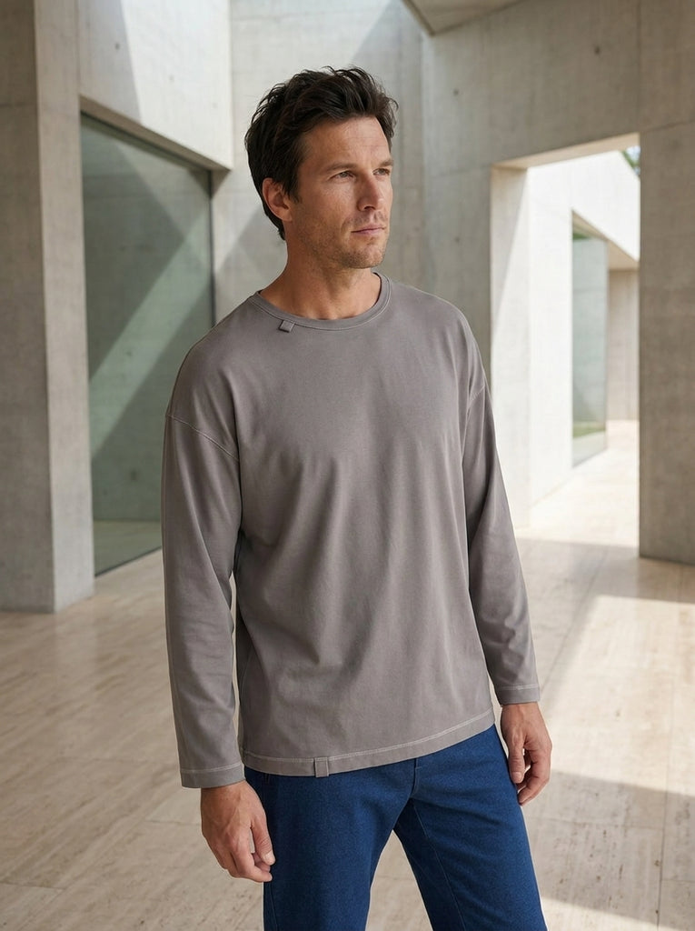Adult wearing the stone grey loose-fit sensory longsleeve in breathable bamboo-cotton